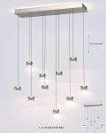 Lampa wisząca Quiberon z 10 źródłami LED o mocy 55W, wykonana z niklu. Posiada prostokątną, metalową podstawę z regulowanymi linkami, na których zawieszone są szklane klosze w formie kostek. Wymiary: długość 1110 mm, szerokość 310 mm, wysokość 1600 mm.