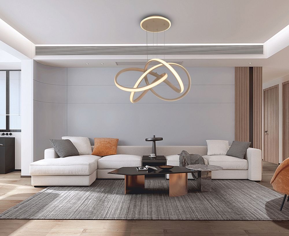 Lampa wisząca Bandol 1xLED 56W w kolorze piaskowym, z unikalnym, nowoczesnym kształtem, zawieszona na cienkich linkach. Umieszczona w eleganckim wnętrzu z jasnym narożnikiem i ciemnym stołem, tworzy stylową aranżację.