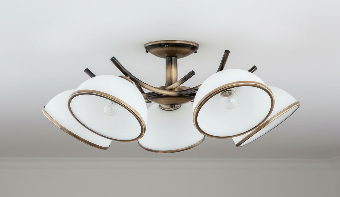 Lampa sufitowa Altea 5-punktowa w kolorze patyny z białymi kloszami. Klosze o okrągłym kształcie z subtelnym złotym wykończeniem, zamontowane na metalowej podstawie. Ujęcie z dołu, ukazujące wszystkie pięć źródeł światła.