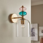 Kinkiet Busco 1xE27 w kolorze mosiądzu z dymionym kloszem. Uchwyt na ścianie z ozdobnymi szklanymi elementami w kolorze różowym i turkusowym. Klosz w formie dzwonu, zamontowany na metalowej podstawie.