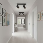 Lampa sufitowa Nicea w kolorze czarnym i złotym, z dwoma reflektorami GU10, zamontowana na suficie w jasnym korytarzu. Widoczne są również obrazy na ścianach oraz meble w tle.