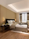 Kinkiet Huaral 1xLED 9W w kolorze złotym, zamontowany po obu stronach łóżka w eleganckiej sypialni. Świeci ciepłym światłem, podkreślając nowoczesny design i przytulną atmosferę. W tle widoczne meble i dekoracje w stonowanej kolorystyce.
