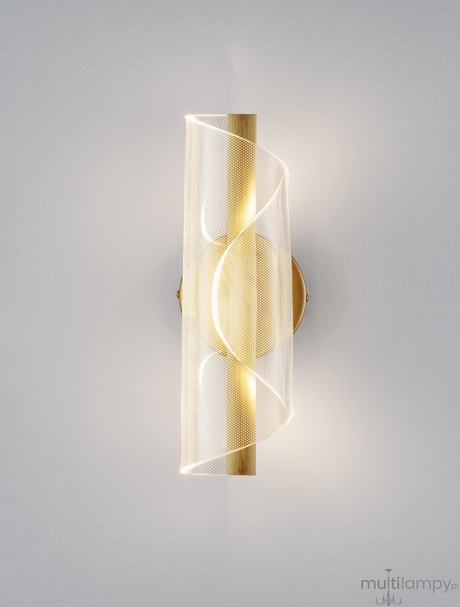 Huaral kinkiet 1xLED 9W w kolorze złotym. Lampa ma nowoczesny, falisty klosz z transparentnego materiału oraz metalową podstawę. Ujęcie frontalne, kinkiet zamontowany na ścianie, emituje ciepłe światło. Tło w jasnym kolorze.