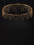Lampa wisząca Huaraz D80 w kolorze złotym, okrągła, z jednym źródłem LED o mocy 31W. Zawiera wiszące elementy świetlne w postaci cienkich prętów, tworząc efektowną iluminację. Ujęcie frontalne na czarnym tle.