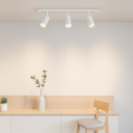 Zestaw szynowy 1m Pipe Ring Track z trzema lampami GU10 w kolorze białym, zamontowany na jasnej ścianie. Lampa ma cylindryczne klosze skierowane w dół, a w tle widoczne są minimalistyczne meble i dekoracje.