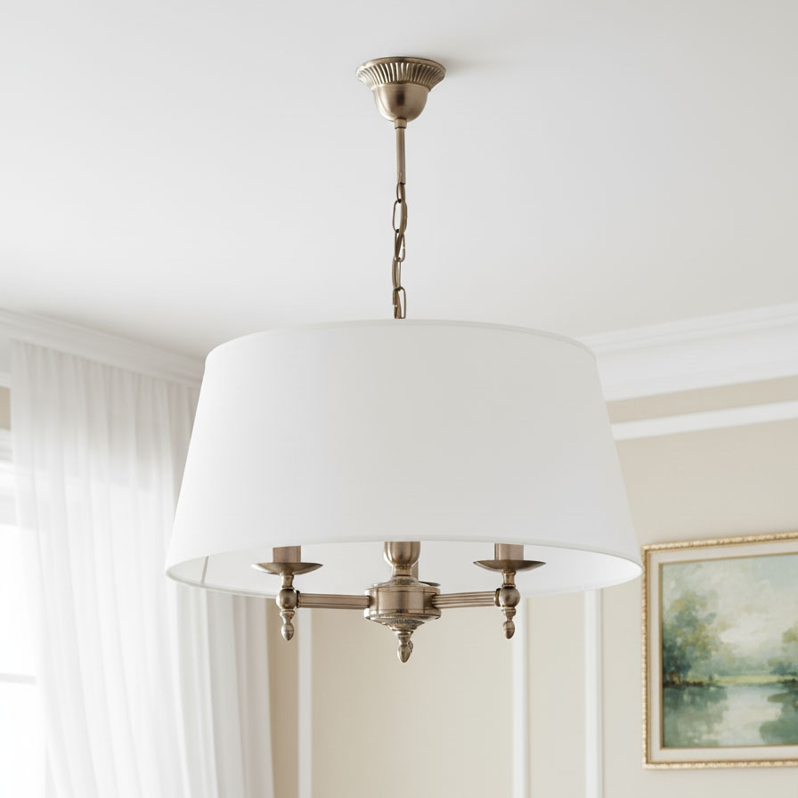 Żyrandol Roksana 3-punktowy w kolorze białym z metalowymi detalami. Okrągły klosz podwieszony na łańcuszku, z trzema źródłami światła. Widok frontalny, z tłem w jasnych odcieniach. Idealny do eleganckich wnętrz.