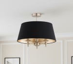 Lampa sufitowa Roksana z trzema miejscami na żarówki E14, w kolorze antycznego złota i czarnego abażura. Kształt cylindryczny, zawieszona pod sufitem. Złote wnętrze abażura odbija światło, tworząc przytulną atmosferę.