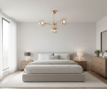 Złota lampa wisząca Primery Gold z trzema oprawami E14, umieszczona centralnie w nowoczesnej sypialni. W tle widoczne łóżko, stoliki nocne oraz rośliny. Szklane klosze lampy tworzą elegancki kontrast z minimalistycznym wystrojem.