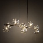 Lava Brown lampa wisząca z 9 źródłami światła G9, brązowa metalowa konstrukcja z przezroczystymi, organicznymi kloszami. Lampa zawieszona na czarnych przewodach, w nowoczesnym stylu, idealna do aranżacji wnętrz.