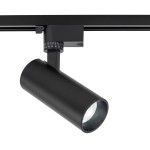 Reflektor spot Tracer 1xLED 10W CCT w kolorze czarnym, zamontowany na szynie 1-fazowej. Cylinder o matowej fakturze z regulacją kąta świecenia. Widoczna soczewka wewnętrzna, metalowa konstrukcja, minimalistyczny design.