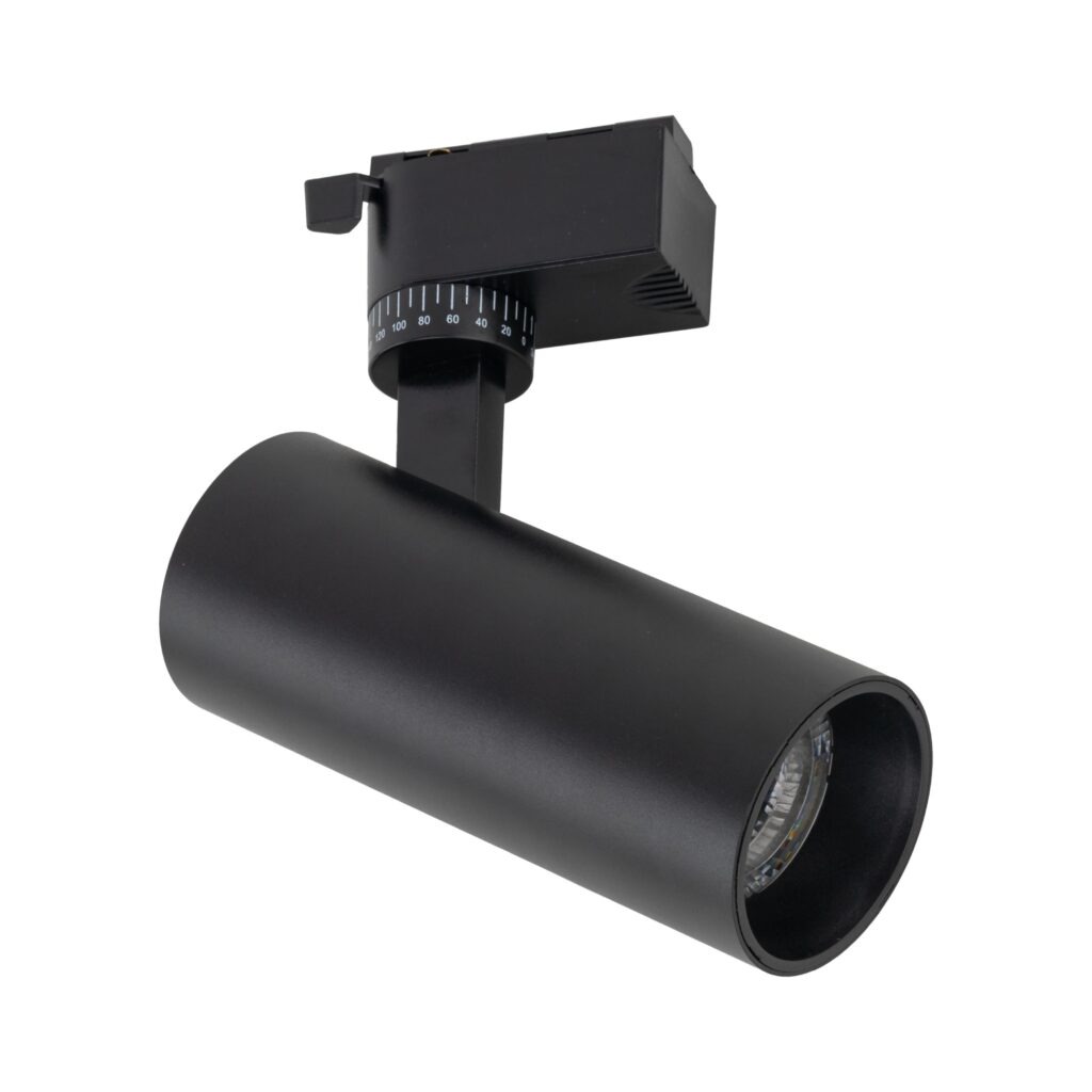 Reflektor spot Tracer 1xLED 10W CCT w kolorze czarnym, zamontowany na uchwycie do szyny 1-fazowej. Cylindryczny kształt, matowa powierzchnia, regulacja kąta świecenia. Widoczna soczewka LED z przodu, elementy mocujące na górze.
