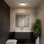 Plafon Maya LED D33 w kolorze czarnym, o mocy 15W i temperaturze barwowej 4000K, zamontowany na suficie. Okrągły kształt, z mlecznym kloszem, w nowoczesnej łazience z dodatkami roślinnymi i lustrem. Tło w odcieniach szarości i czerni.