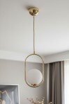 Lampa wisząca Noval M w kolorze złotym z białym, okrągłym kloszem. Zawieszona na cienkim kablu, ma owalną podstawę. Klosz z mlecznego szkła umieszczony w metalowej ramie, stylowy element do nowoczesnych wnętrz.
