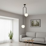 Lampa wisząca Vector 2xE14 w kolorze czarnym i białym, z dwoma okrągłymi kloszami, zawieszona na stylowym, zakrzywionym ramieniu. Ujęcie z dołu w nowoczesnym wnętrzu z sofą i rośliną w tle.
