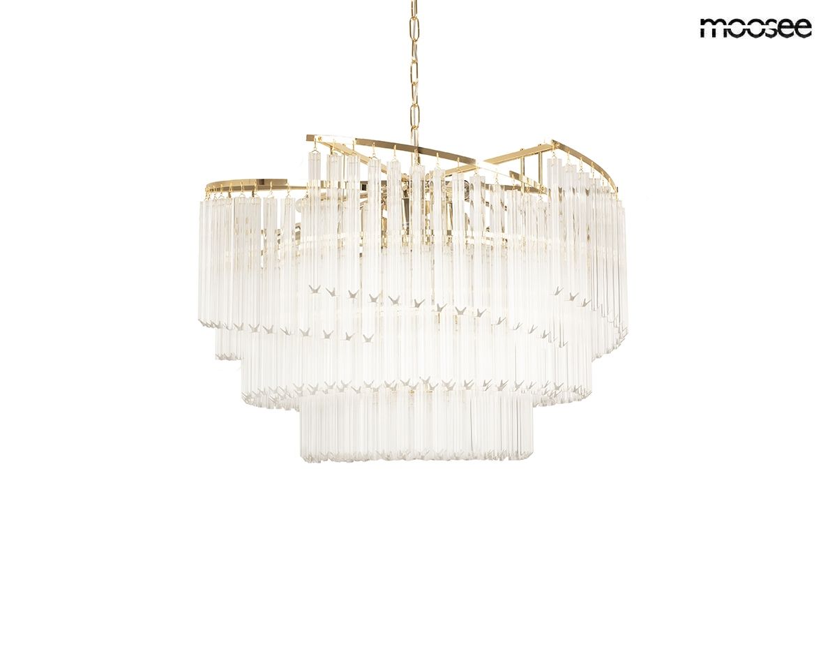 Lampa wisząca Luma 60 w kolorze złotym, z dziewięcioma miejscami na żarówki E14. Posiada przezroczyste, prostokątne elementy szklane w formie kryształów, zawieszone na złotej konstrukcji, w aranżacji na jednolitym tle.
