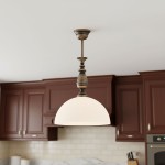 Lampa wisząca Felix D30 z oprawą w kolorze patyny, zawieszona na długim stelażu, z białym, półkulistym kloszem. Produkt umieszczony w kuchni z ciemnymi szafkami na tle jasnej ściany.