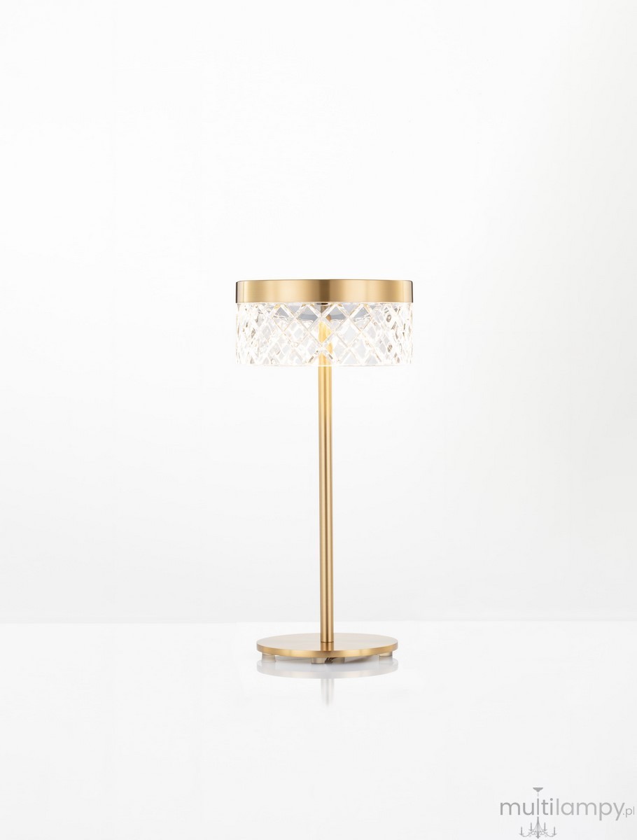 Lampa stołowa Mineros w złotym kolorze, z przezroczystym kloszem o fakturze diamentowej. Stojąca na okrągłej podstawie, z jednym źródłem LED 6W. Elegancki design, idealna do nowoczesnych wnętrz.