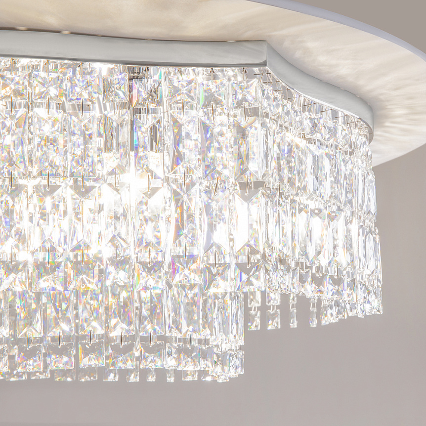 Lampa sufitowa Dune z 10 punktami świetlnymi w chromowanej obudowie, zdobiona przezroczystymi kryształowymi elementami w kształcie prostokątów. Ujęcie z bliska, ukazujące detale kryształów i ich blask.