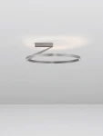 Lampa sufitowa Zudanez 1xLED 44W CCT w kolorze niklowym, o okrągłym kształcie. Zainstalowana na suficie, z delikatnym światłem emitowanym z pierścienia. Prosty, nowoczesny design na jasnym tle.