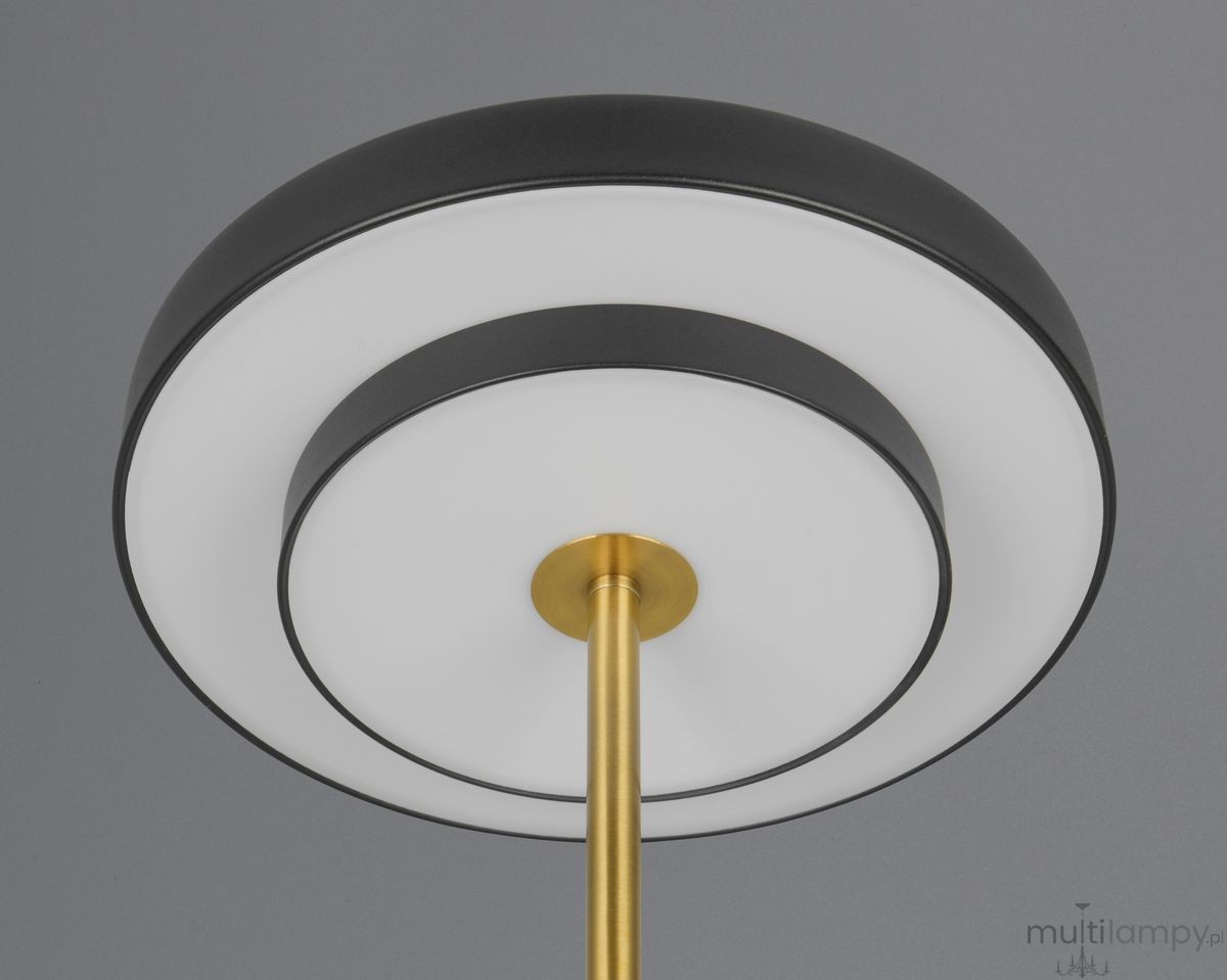 Lampa stołowa Keaton w kolorze czarnym i złotym, z okrągłym kloszem z białego materiału, z metalowym stelażem. Widok od dołu, ukazujący detale konstrukcji oraz elegancki design. Umożliwia zastosowanie żarówki LED 12W CCT.