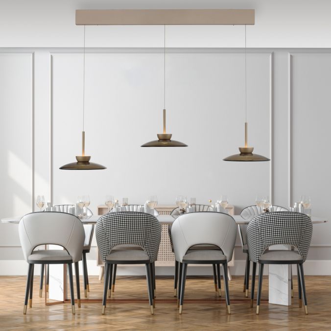 Lampa wisząca Pure Moon 6xLED 47 W, w kolorze czarnym z metalowymi detalami, zawieszona nad eleganckim stołem z krzesłami o białym i szarym obiciu. Prosty, nowoczesny design w jasnym wnętrzu.