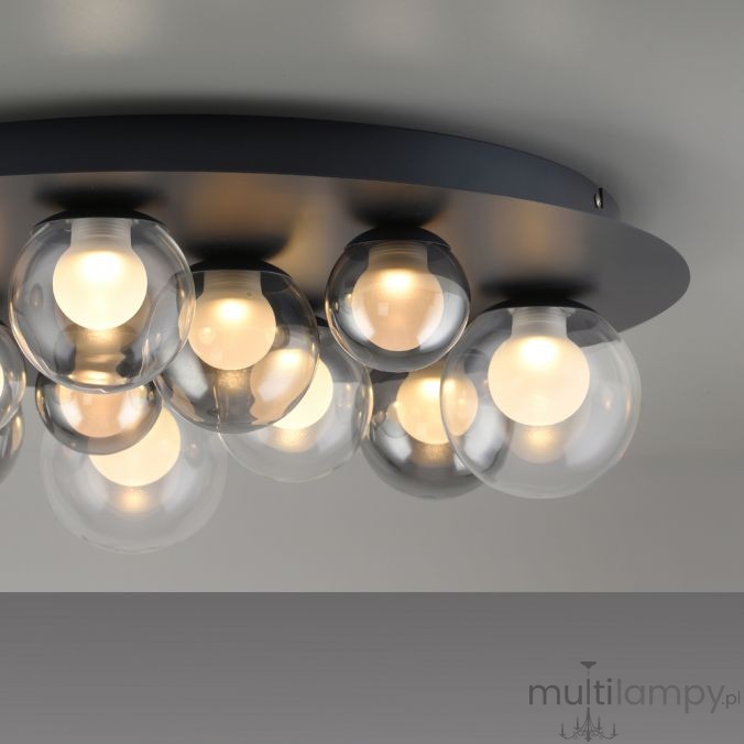 Lampa sufitowa Pure Popup, grafitowa, z 11 okrągłymi kloszami z przezroczystego szkła, emitującymi ciepłe światło. Zainstalowana na okrągłej, matowej podstawie. W komplecie pilot do zdalnego sterowania.
