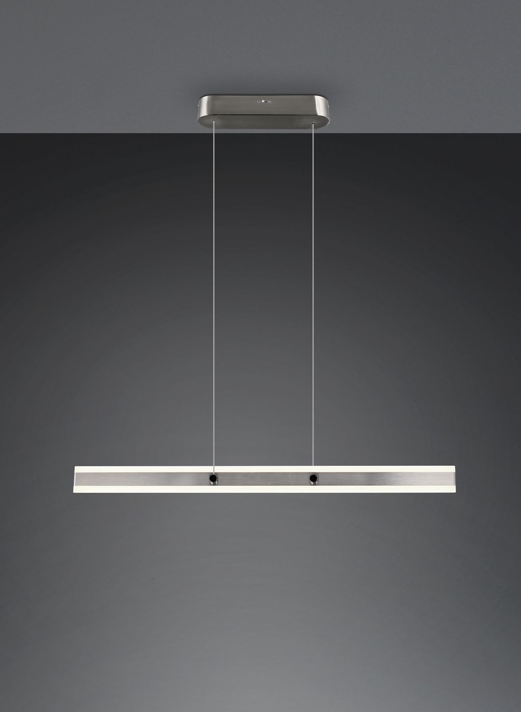 Lampa wisząca Arcola w kolorze niklu z jedną diodą LED 35W. Prosty, prostokątny kształt z metalowym wykończeniem, zawieszona na przezroczystych linkach. Montaż sufitowy, w minimalistycznym stylu, idealna do nowoczesnych wnętrz.