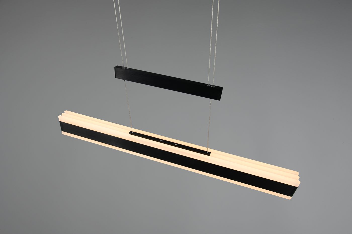 Lampa wisząca Arcola 1xLED 45W CCT w kolorze czarnym, o prostokątnym kształcie z matowym wykończeniem. Składa się z górnej, czarnej części oraz dolnej, białej, żłobkowanej oprawy. Zawieszona na cienkich linkach, prezentuje nowoczesny design.