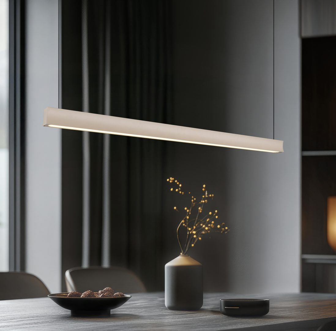 Lampa wisząca Wallace 1xLED 29W CCT w kolorze beżowym, w prostokątnym kształcie, zawieszona nad drewnianym stołem. W tle widoczny czarny talerz z czekoladkami oraz dekoracyjny wazon z gałązkami.