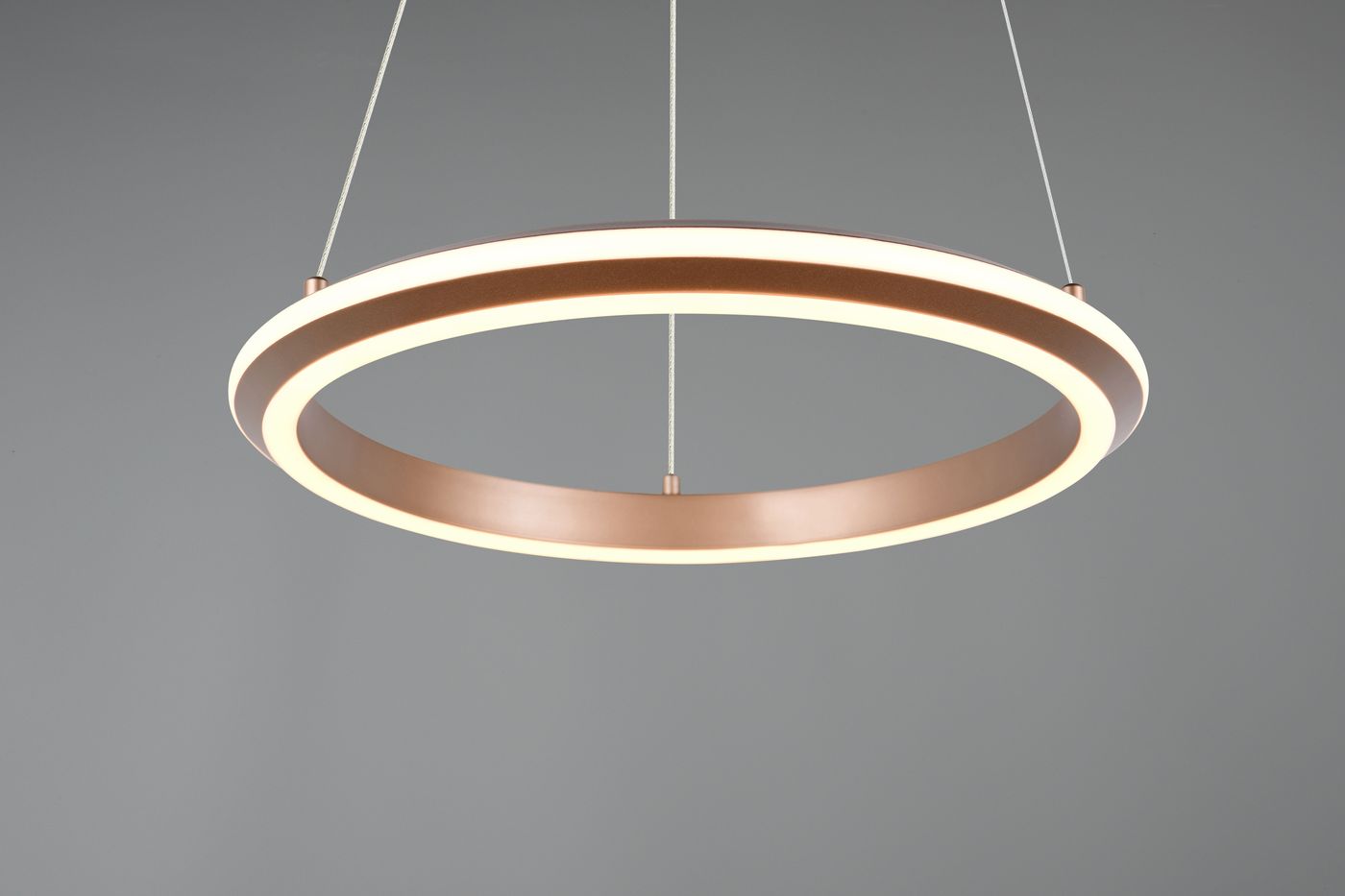 Lampa wisząca Amador w kolorze kawowym, z okrągłym kształtem i podwójnym pierścieniem LED. Zawieszona na cienkim sznurku, oświetlenie ma 34W. Tło jest szare, co podkreśla elegancki design lampy.