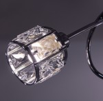 Lampa wisząca Aurora 3xE14 w kolorze chromu, z ozdobnymi kryształowymi elementami na kloszu. Klosz w kształcie cylindrycznym, z widocznym źródłem światła, zawieszony na cienkim ramieniu. Tło ciemne, podkreślające elegancję lampy.