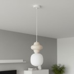 Kremowa lampa wisząca Latera D15 z jednym gniazdem E14. Posiada charakterystyczny kształt z górną częścią w formie zaokrąglonego klosza oraz dolnym, szklanym elementem w białym kolorze. Montowana na białym przewodzie, zawieszona z sufitu.