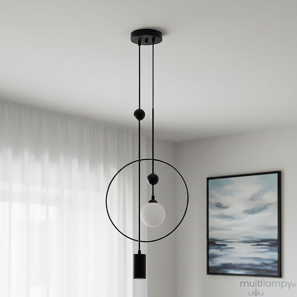 Lampa wisząca Trosti 2-punktowa, czarna. Konstrukcja z okrągłym elementem oraz szklanym kloszem w kształcie kuli. Dwa przewody zawieszone w pionie, zamontowana na suficie. Tło w jasnym kolorze z zasłonami i obrazem w ramie.