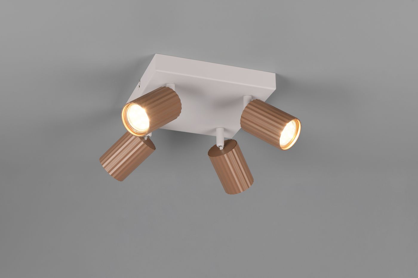 Lampa sufitowa Soka w kolorze szarym z czterema regulowanymi reflektorami w odcieniu kawowym. Ujęcie z dołu, ukazujące detale cylindrycznych kloszy z widocznymi żarówkami GU10. Montowana na płaskim, kwadratowym wsporniku.