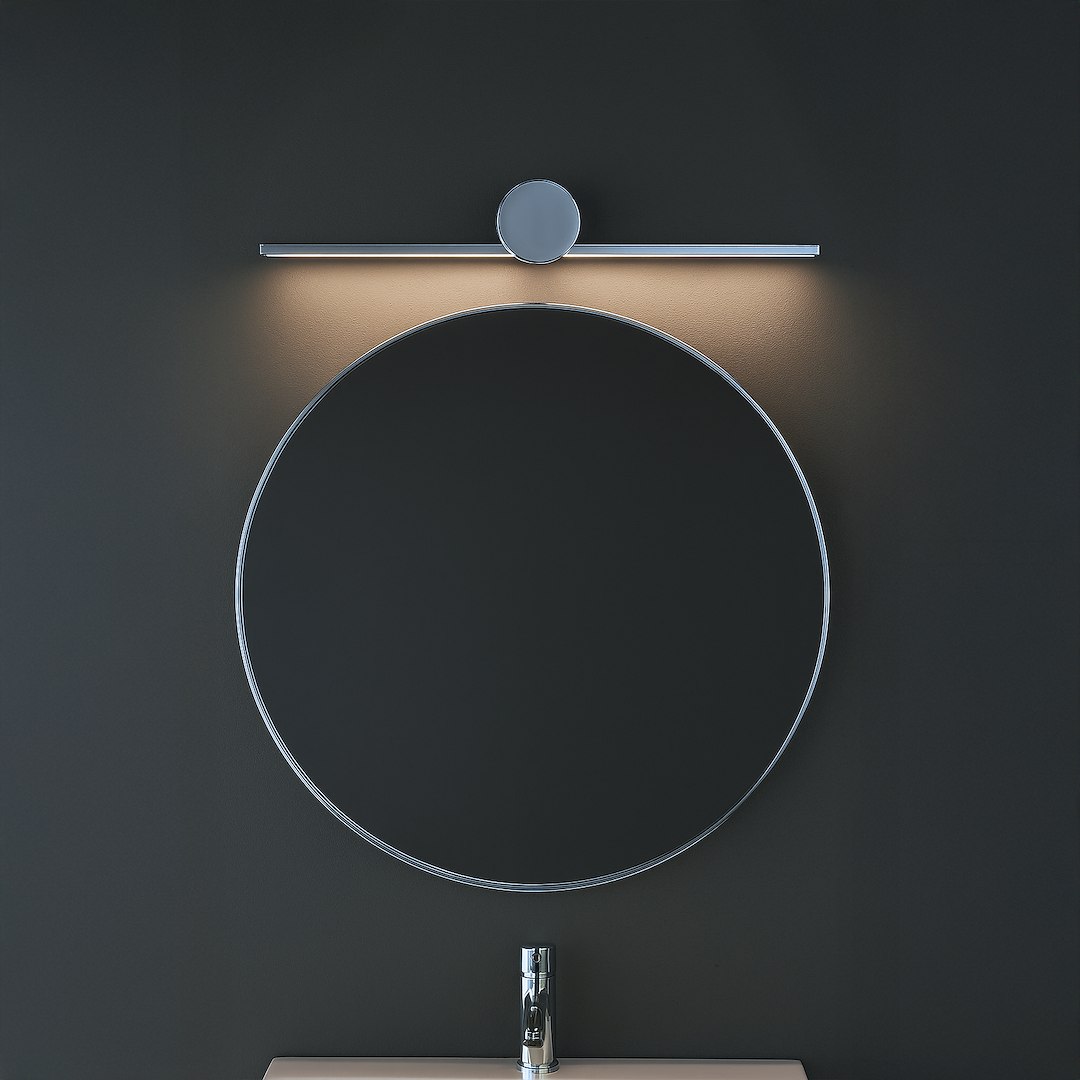 Kinkiet Artist L40,5 LED 6W 4000K IP44 w kolorze chromu, zamontowany nad okrągłym lustrem. Oświetlenie skierowane w dół, na tle ciemnej ściany. Stylowy, minimalistyczny design z okrągłym elementem centralnym.