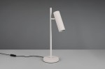 Szara lampa stołowa Soka z jedną oprawą GU10, z prostym, cylindrycznym kloszem o żebrowanej fakturze, umieszczona na okrągłej podstawie. Ujęcie z boku, kabel z włącznikiem widoczny na stole.