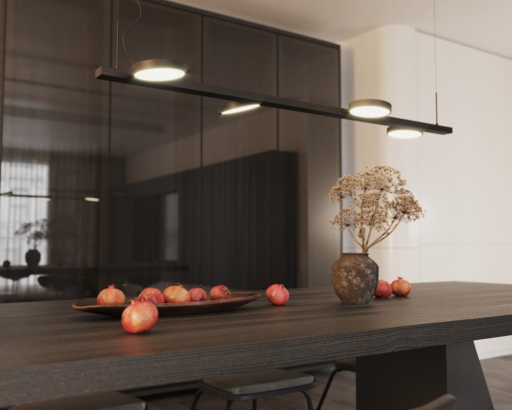 Lampa wisząca Ibiza 4xLED 32W w kolorze czarnym, umieszczona nad ciemnym stołem. Zawiera cztery okrągłe źródła światła, w tle widoczne dekoracje i owoce na talerzu. Tło w odcieniach ciemnych, z dużymi oknami.