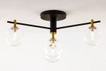 Lampa sufitowa Figaro w kolorze czarnym z przezroczystymi kloszami. Posiada cztery oprawy G9, metalową konstrukcję z elementami w złotym kolorze. Ujęcie z dołu, ukazujące położenie kloszy oraz detal konstrukcji.