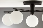Lampa sufitowa Prato w kolorze czarnym z pięcioma okrągłymi kloszami z białego matowego szkła. Ujęcie z dołu, ukazujące detale mocowania i rozłożenie ramion, które trzymają klosze. Prosta konstrukcja, idealna do nowoczesnych wnętrz.