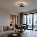 Lampa sufitowa LED 12W 4000K w kolorze czarnym, z podwójnym okręgiem, umieszczona na suficie. Oświetlenie w nowoczesnym wnętrzu z jasnymi ścianami, drewnianą kuchnią i oknami, tworzy elegancką atmosferę.