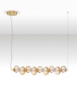 Lampa wisząca Tanvera z jedną żarówką LED 30W, złota z bursztynowymi, szklanymi kloszami w kształcie kul. Zawieszona na cienkim przewodzie, z okrągłym, złotym mocowaniem sufitowym. Elegancki design pasujący do nowoczesnych wnętrz.