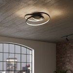 Czarna lampa sufitowa LED Turner o mocy 32W, 4000K, z charakterystycznym designem składającym się z dwóch okręgów, zawieszona na tle surowego sufitu. Oświetlenie tworzy nowoczesny efekt świetlny w pomieszczeniu.
