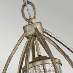 Lampa wisząca Rosalie w kolorze starego jasnego złota, z metalową konstrukcją składającą się z cienkich, stylowych ramion. Na górze znajduje się okrągłe mocowanie, a u dołu szklany klosz z dekoracyjnym wzorem.