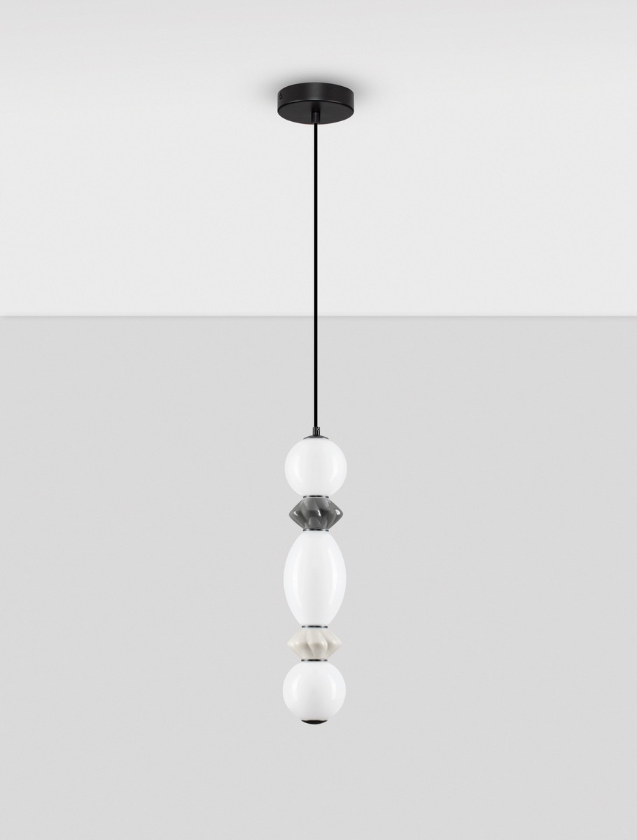 Lampa wisząca Monreta z jednym źródłem LED 14W, w kolorze czarnym. Składa się z trzech różnokolorowych elementów szklanych: białego, szarego oraz kremowego, zawieszona na czarnym przewodzie. Stworzona do nowoczesnych wnętrz.