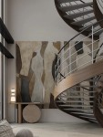 Lampa stołowa Felanzo 1xLED 23W w kolorze złotym z multikolorowymi akcentami, stojąca na okrągłym stoliku. Wyposażona w trzy różnokolorowe klosze, umieszczona w nowoczesnym wnętrzu z abstrakcyjnymi obrazami na ścianie i spiralnymi schodami w tle.