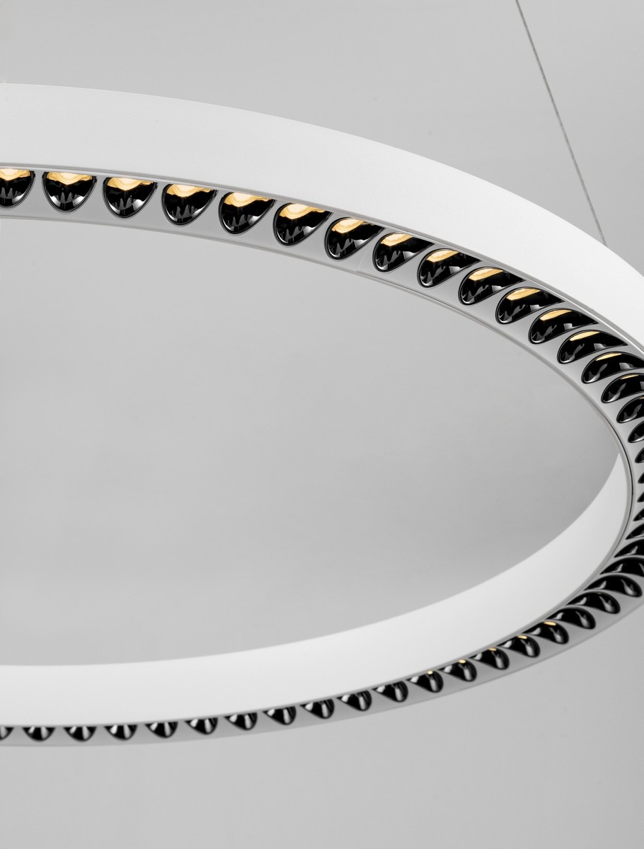 Lampa wisząca Tarvana 1xLED 27W w kolorze białym, z okrągłym abażurem. U góry widoczne czarne detale, które odzwierciedlają światło. Kąt ujęcia z góry, prezentujący strukturę i wykończenie lampy.