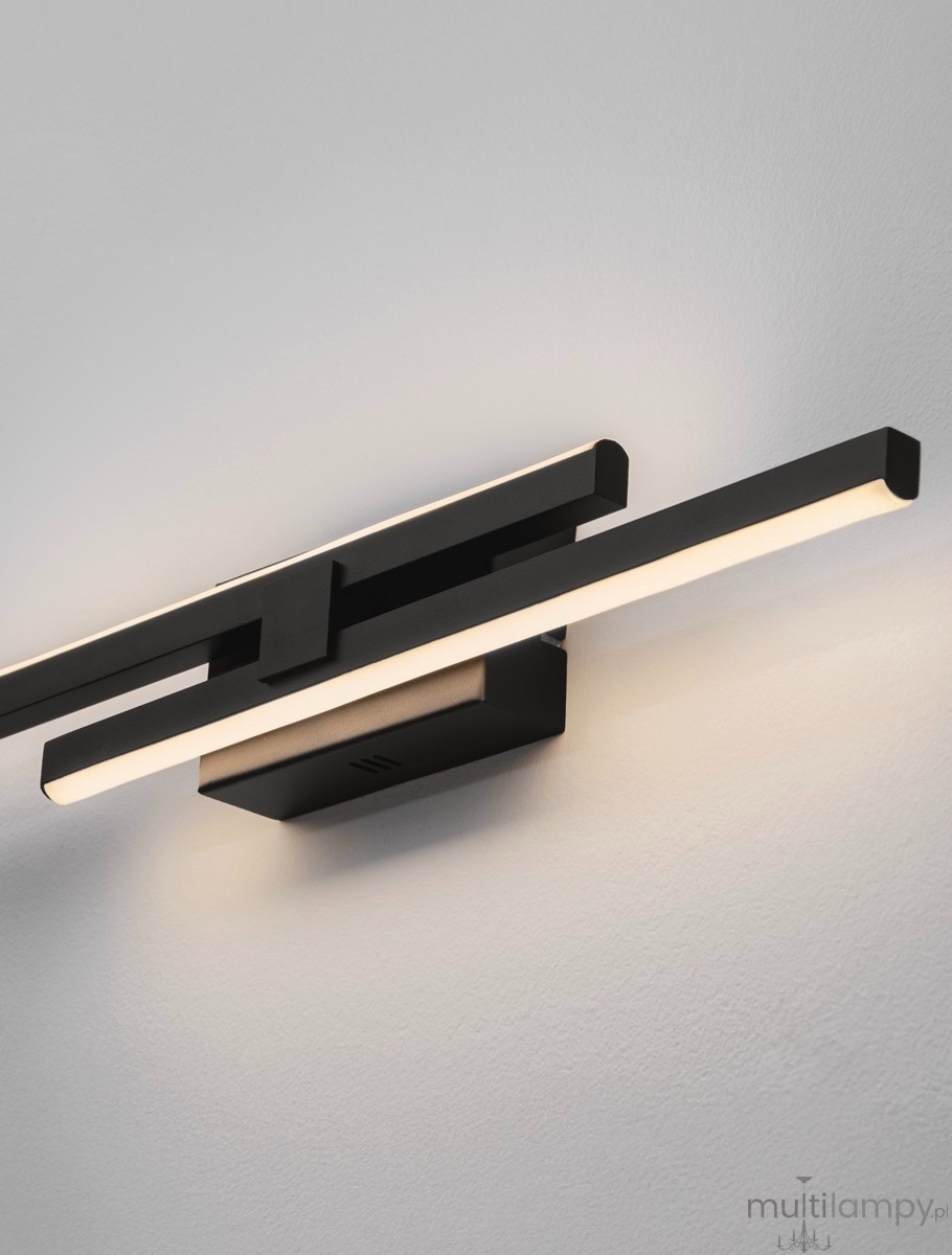 Felvira kinkiet 2xLED 12W w kolorze czarnym, z minimalistycznym designem. Ułożony poziomo, z dwoma prostokątnymi źródłami światła LED w ciepłym odcieniu, zamontowany na gładkiej, jasnej ścianie. Wymiary i szczegóły konstrukcyjne są niewidoczne.