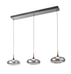 Lampa wisząca Tenele 21W 3000K w srebrnym kolorze, z trzema zaokrąglonymi kloszami i cienkimi zawieszeniami, montowana na prostokątnej podkładce. Klosze mają połyskującą powierzchnię, emitującą ciepłe światło.