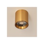Lampa sufitowa LED 10W CCT w kolorze złotym, cylindryczna, z metaliczną obudową. Widoczna okrągła źródło światła w centralnej części, umieszczona na białym tle. Kąt ujęcia: z dołu, podkreślający nowoczesny design.