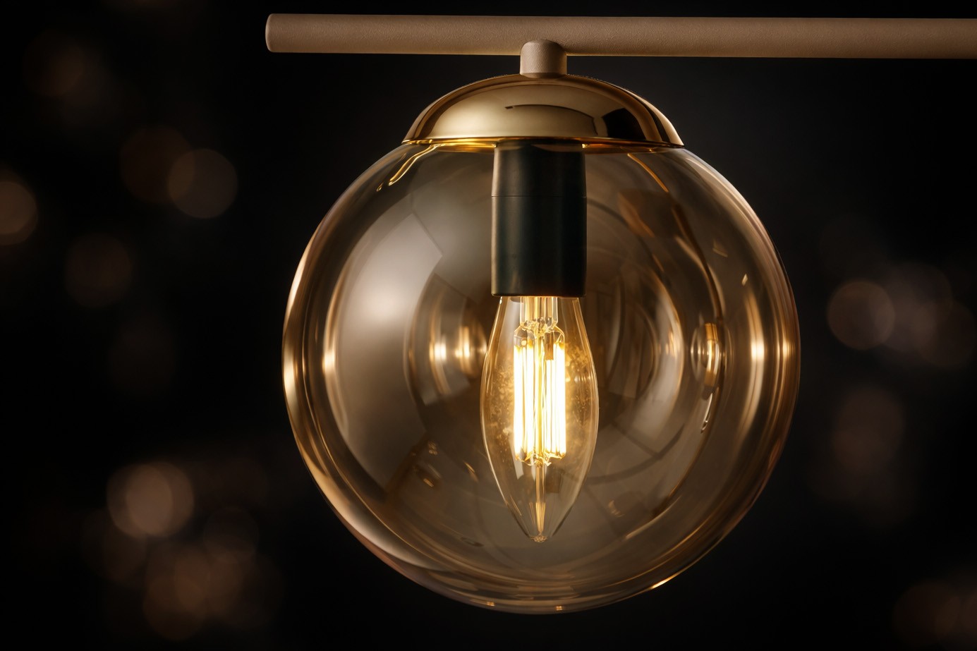 Lampa sufitowa Felix 4xE14 w beżowej obudowie z bursztynowym, szklanym kloszem. Widoczne żarówki w stylu retro, zawieszone na metalowej listwie. Kąt ujęcia zbliżony, ukazujący detal klosza i źródła światła. Tło ciemne, podkreślające elegancję lampy.